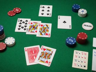 Overhead photo of a clean Texas Hold’em setup on green felt: A♥ K♥ as