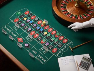 Overhead photo of a European single-zero roulette table: chips arranged on various bet types