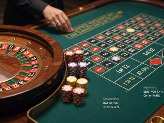 Fotografische Szene eines europäischen Roulette-Tisches: scharfes Rad mit rollender Kugel, klar sichtbares Setzfeld mit